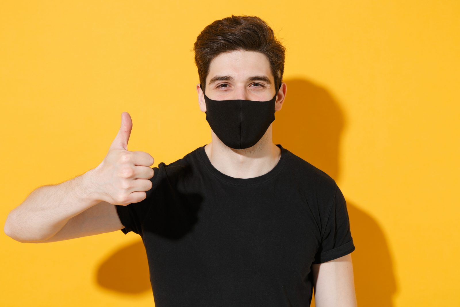man in mask giving thumbs up